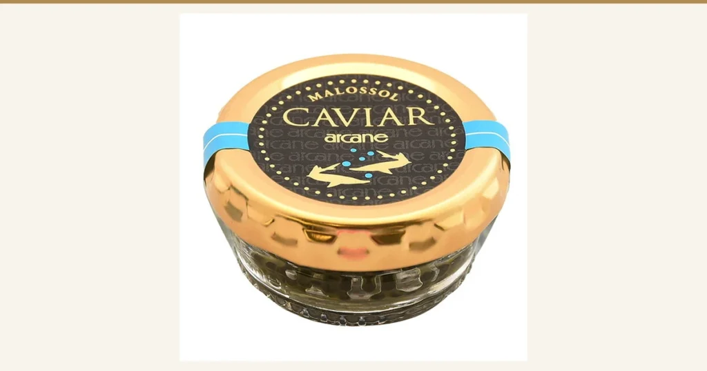 Featured image for the French caviar 18g article. Product photo of a glass jar of caviar with a gold lid and a light-blue band; the lid is printed "MALOSSOL CAVIAR arcane"