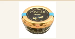 Featured image for the French caviar 18g article. Product photo of a glass jar of caviar with a gold lid and a light-blue band; the lid is printed "MALOSSOL CAVIAR arcane"