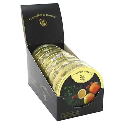 Product photo of Cavendish & Harvey Mixed Fruit Candy in tins. An open black display box shows 7 round tins arranged at an angle; the front tin's label shows illustrations of orange, lemon and cherry, plus a barcode sticker. Text the shop put in the image: "Cavendish & Harvey", "Mixed Fruit Drops", "Premium Quality", "Made in Germany".