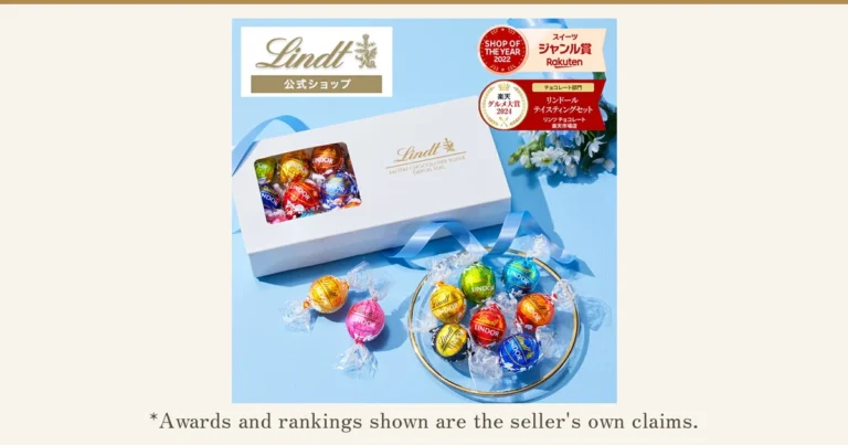 Product photo of a white gift box with a window (Lindor chocolates visible inside), shown on a light-blue background with individually wrapped Lindor chocolates on a plate and in front. Text the shop placed in the image: “Lindt 公式ショップ” (“Lindt Official Shop”), “SHOP OF THE YEAR 2022 スイーツ ジャンル賞 Rakuten” (a Rakuten Sweets genre award badge) and “楽天グルメ大賞 2024 チョコレート部門 リンドール テイスティングセット リンツ チョコレート楽天市場店” (a Rakuten Gourmet Award 2024 chocolate-category badge). Below the photo: “*Awards and rankings shown are the seller's own claims.”