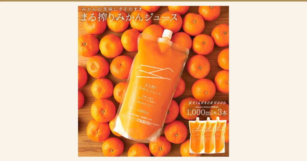 Product page photo of Japanese mikan juice, 100% juice, 1000ml × 3 pouches: a clear spouted pouch labeled “まる搾りみかんジュース 果汁100%ストレート 1,000ml” lies diagonally on a bed of orange mikan, with three smaller pouches at the lower right. Text the shop placed in the image: “みかんの美味しさそのまま”, “まる搾りみかんジュース”, “1,000ml×3本”, “NEIGHBORHOOD Miyazaki_Nichinan Mikan”