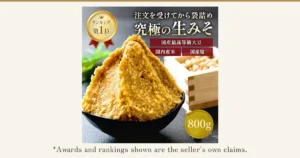Product photo of Yamasa Miso Koji-ten Kuradashi Nama Miso 800g: yellow raw miso heaped in a black bowl, with a wooden box of domestic soybeans on the right. Text the shop placed in the image: “注文を受けてから袋詰め” (bagged after the order is received), “究極の生みそ” (the ultimate raw miso), “ランキング第1位” (No. 1 in ranking), “国産最高等級大豆” (top-grade domestic soybeans), “国内産米” (domestic rice), “国産塩” (domestic salt), “800g”. Below the photo: “*Awards and rankings shown are the seller's own claims.”