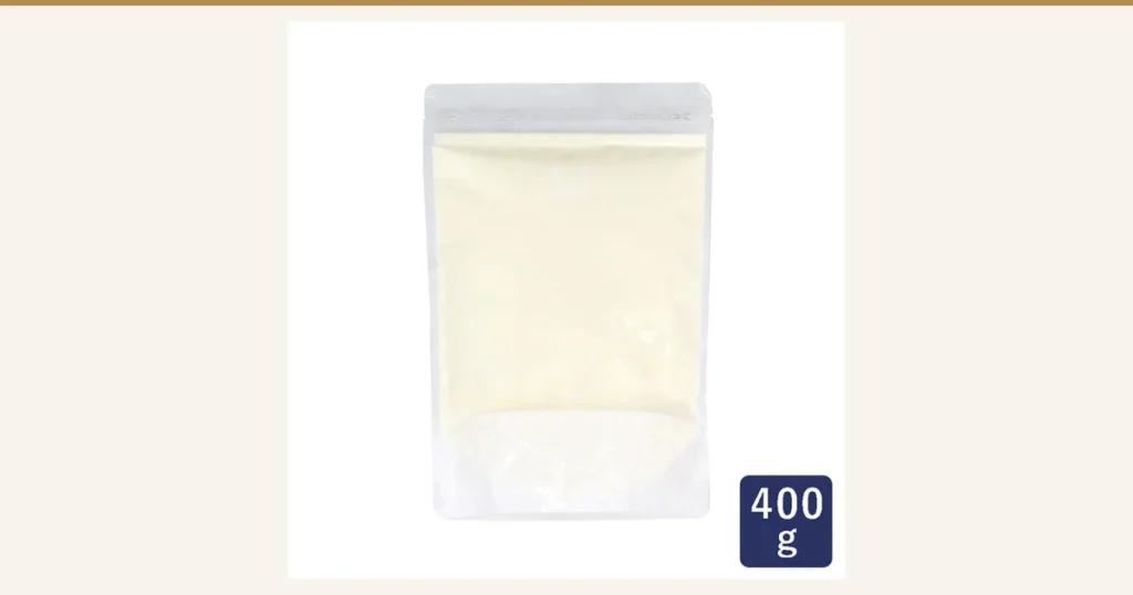A photo of pale cream-colored powder in a clear stand-up pouch. A navy box at the bottom right contains the white text “400g”. ママパン Hokkaido Skim Milk (Skimmed Milk Powder) 400g