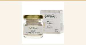 Product photo of White Truffle Salt タルトゥフランゲ 30g: white salt in a small glass jar with a gold lid, with a white box standing behind it to the right. The jar label and the box are printed with “Tartuf Langhe”, “WHITE TRUFFLE SALT” and “30g”