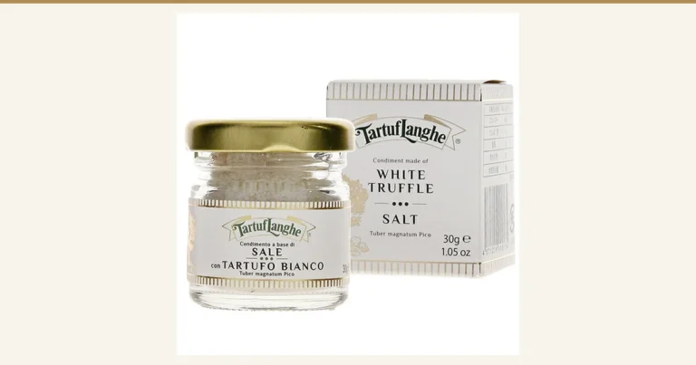 Product photo of White Truffle Salt タルトゥフランゲ 30g: white salt in a small glass jar with a gold lid, with a white box standing behind it to the right. The jar label and the box are printed with “Tartuf Langhe”, “WHITE TRUFFLE SALT” and “30g”