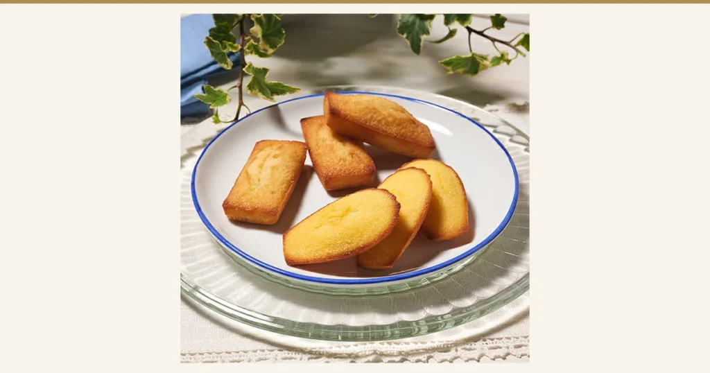 Photo of 3 financiers and 3 madeleines on a plate, from the Henri Charpentier Financier and Madeleine Assortment, 19 Pieces (baked sweets).