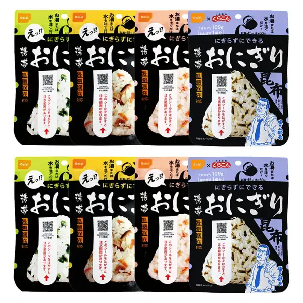 尾西食品 携帯おにぎり（便携饭团）8食装（五目・昆布・鮭・わかめ各2个）的商品照片。黑色底色的袋子分上下两排、每排4袋，共8袋。从左起依次为わかめ・五目・鮭・昆布的袋子，袋上印有「携帯おにぎり」（便携饭团）「にぎらずにできる」（无需用手捏）「長期保存対応」（适合长期保存）「写真はイメージです」（照片仅供参考）的字样
