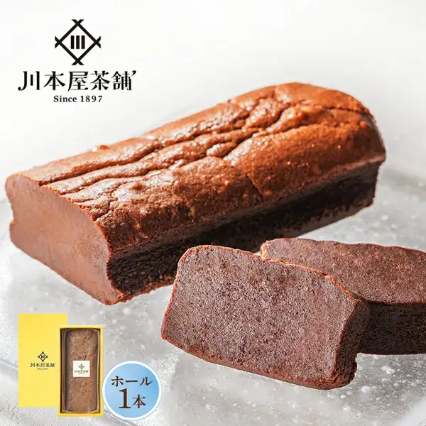 Product photo of Kawamotoya Chaho Rich Gateau au Chocolat, Whole Size: one long chocolate cake and two cut slices showing the cross-section, with a small photo of the yellow gift box and boxed cake at lower left. Text the shop placed in the image: the shop logo “川本屋茶舗 Since 1897” and “ホール1本” (1 whole cake).
