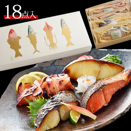 鳥取門永 西京漬&粕漬ギフトセット「雅」6種18点の商品写真。焼き上げた銀だら・紅鮭・さわらの切り身とイカが皿に盛られ、レモン、すだち、しそ、みょうが、大根おろしなどが添えられている。右上に金色の魚の絵柄の外箱と、個包装された切り身が写っている。店舗が画像に入れた表示として「18点入」の文字あり。