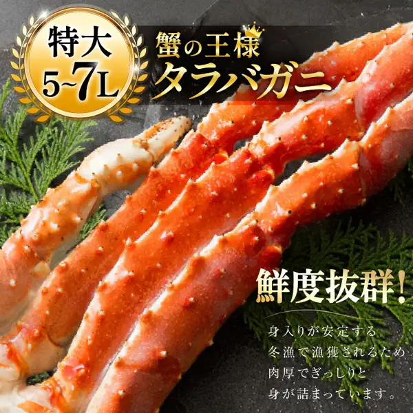 Product photo of boiled king crab legs on a dark background (本タラバガニ脚 ボイル済). Text the shop placed in the image reads: "特大 5~7L" (extra large, 5-7L), "蟹の王様 タラバガニ" (king of crabs, king crab), "鮮度抜群!" (outstanding freshness) and a line saying the meat is plump and densely packed because the crab is caught in the winter fishing season.